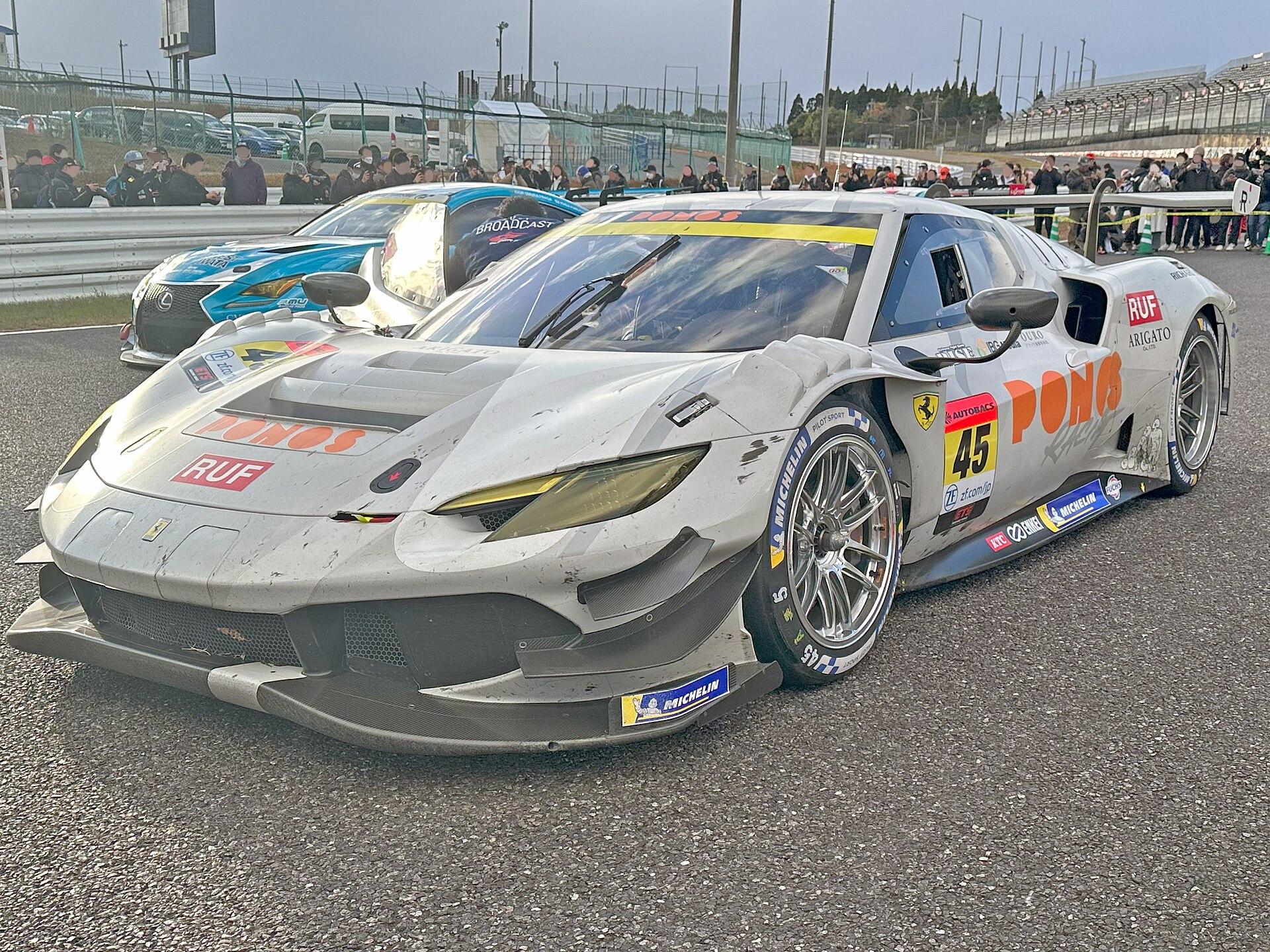 A Ferrari 296 GT3 racing car on track at Suzuka.
