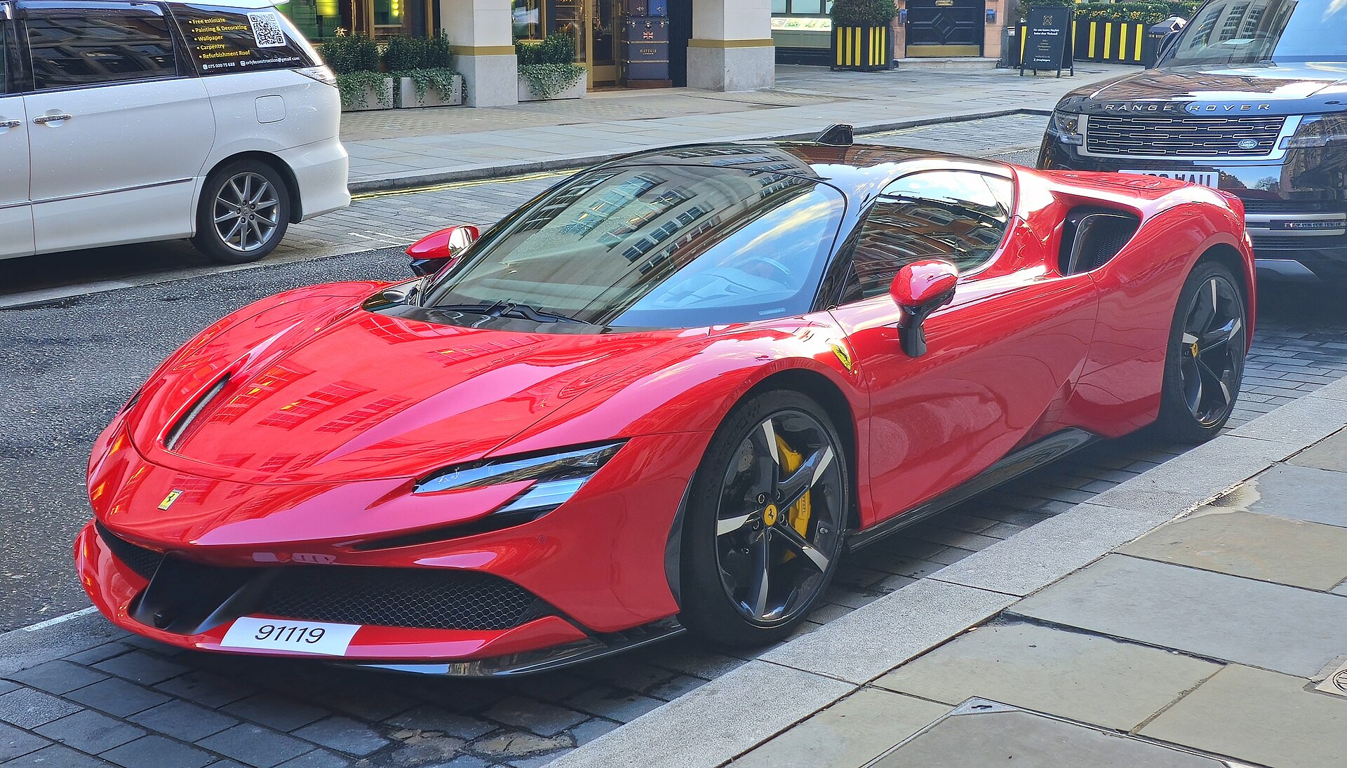 Ferrari SF90 Stradale in Rosso Corsa, three-quarter front, parked on a Mayfair street.