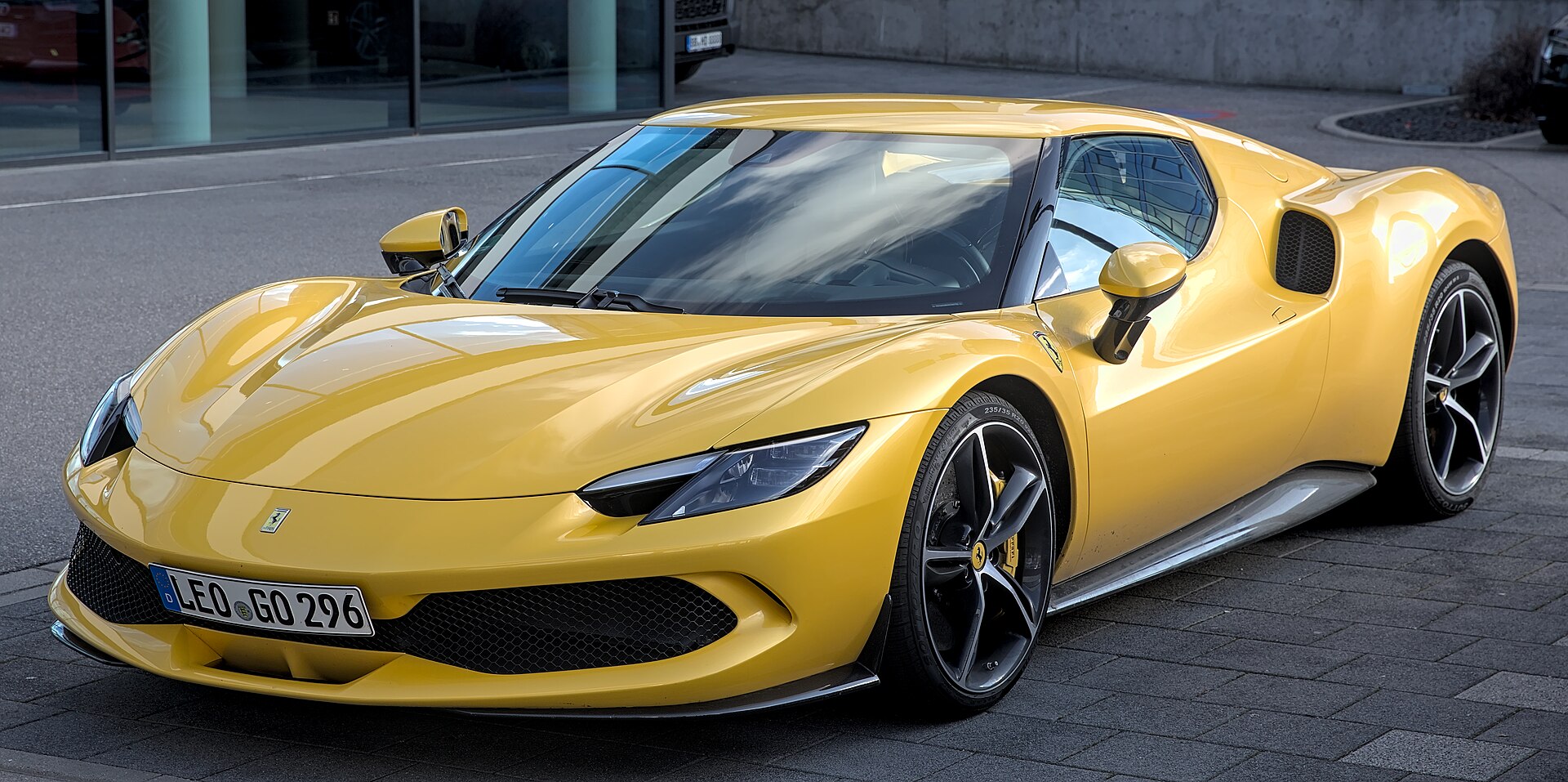 Ferrari 296 GTB in Giallo Modena, three-quarter front.